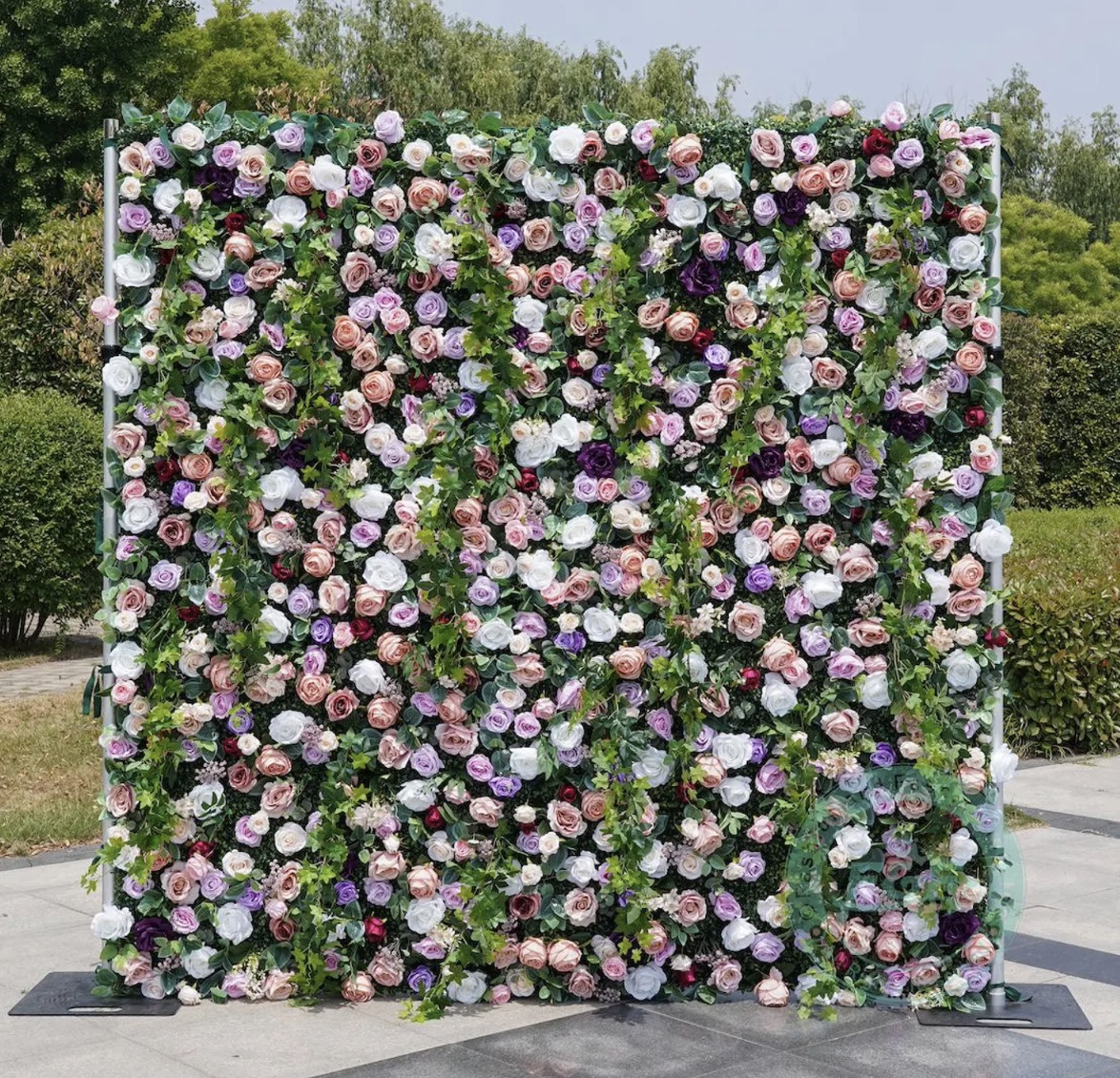 The Secret Garden flower wall rental with pink, purple, white, and greenery florals for Nashville events.